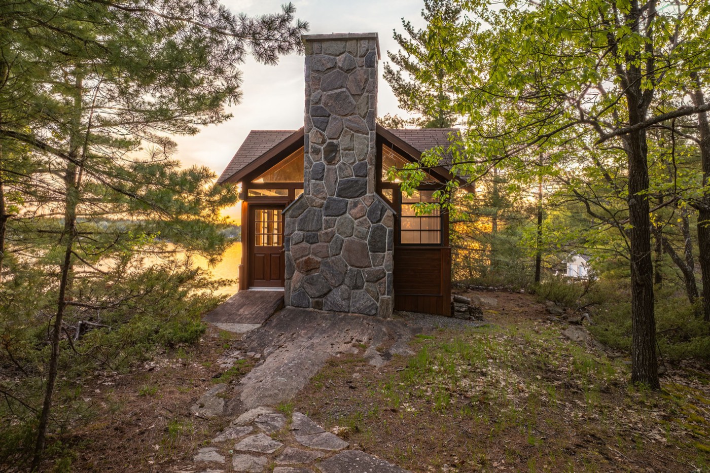 Stone lakeside cabin at dusk